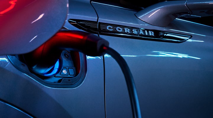 A charger plugged into the charging port of a 2024 Lincoln Corsair® Plug-in Hybrid model. | Asheville Lincoln in Asheville NC