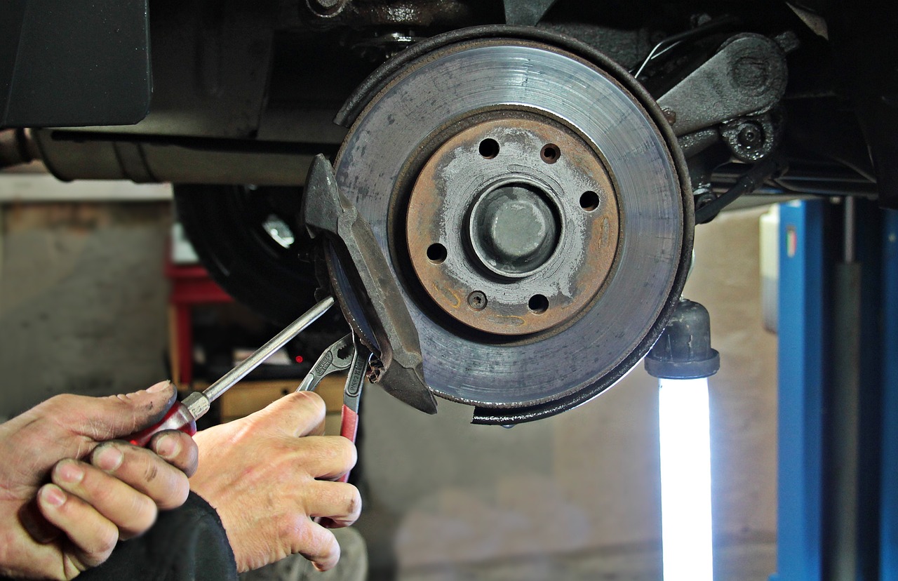 A mechanic working on a car's wheel