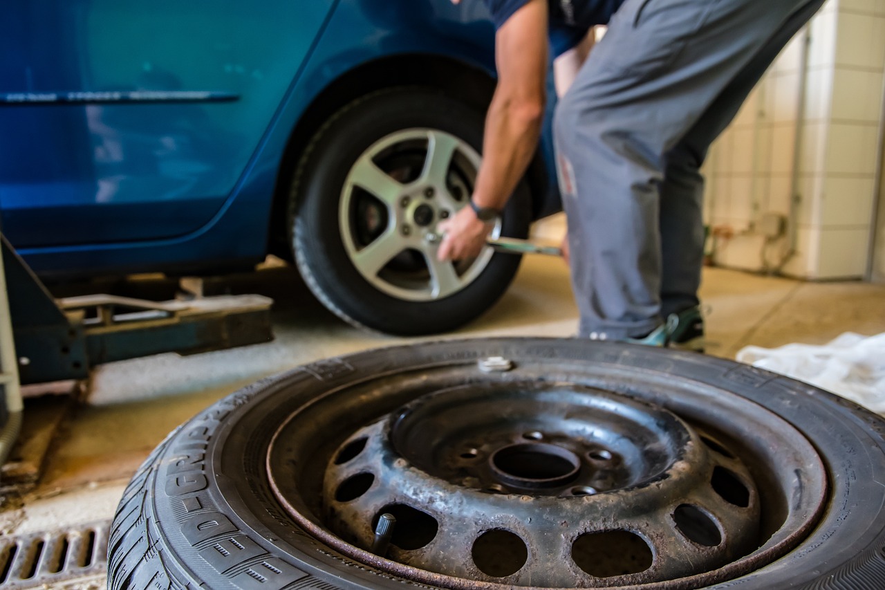 A mechanic replacing the tires on a car