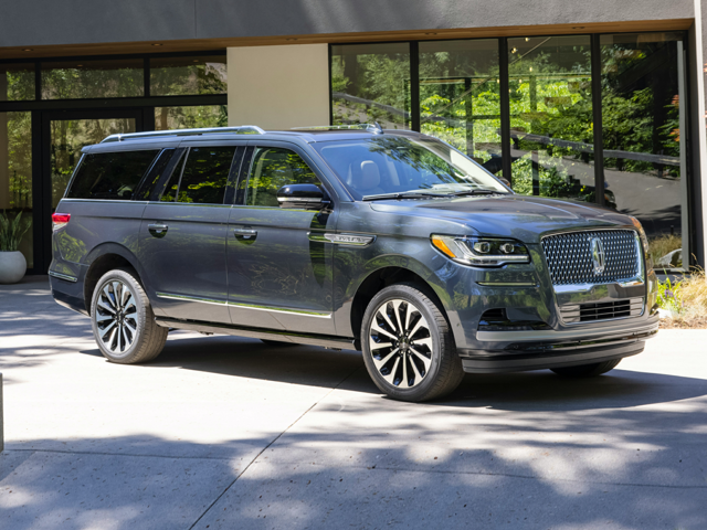 A Lincoln Navigator parked outside of a building