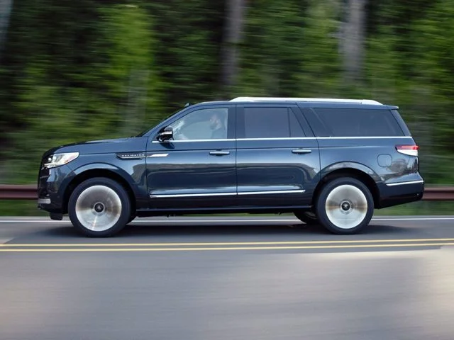 A Lincoln Navigator driving on a road