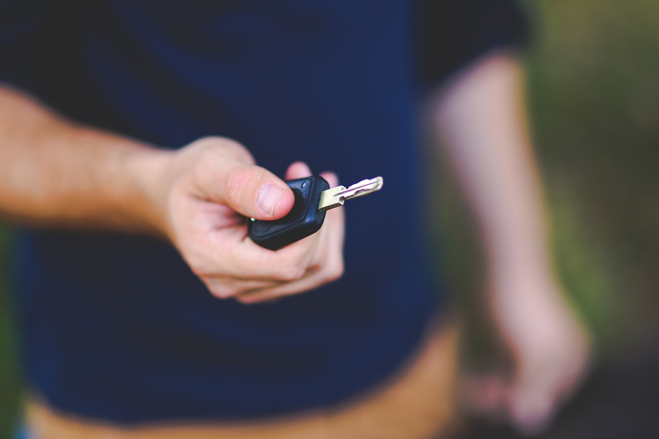 A person handing a car key