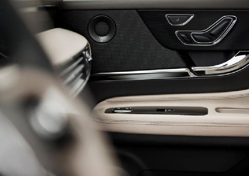 A black available Revel Waveguide door speaker contrasting texture provides clarity from the sound system