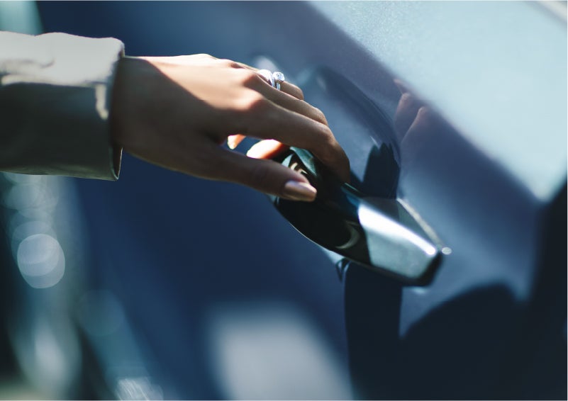 A hand gracefully grips the Light Touch Handle of a 2023 Lincoln Aviator® SUV to demonstrate its ease of use | Asheville Lincoln in Asheville NC