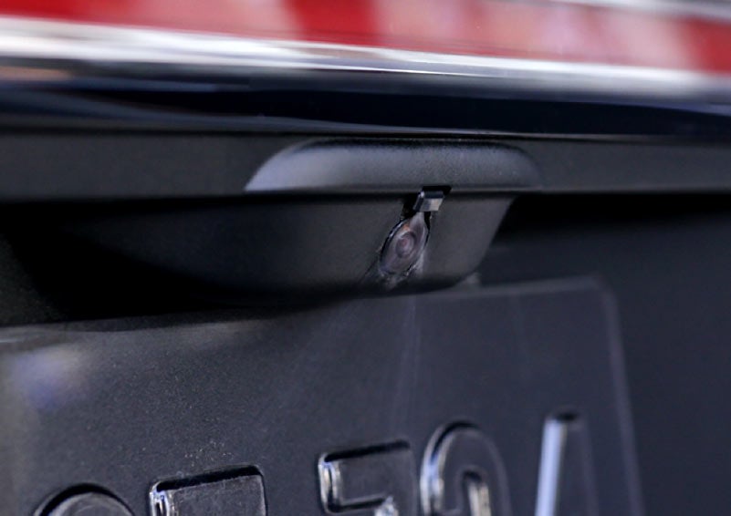 The rear camera wash is shown spraying the camera lens to clean it.