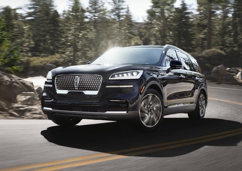A Lincoln Aviator® SUV is being driven on a winding mountain road | Asheville Lincoln in Asheville NC