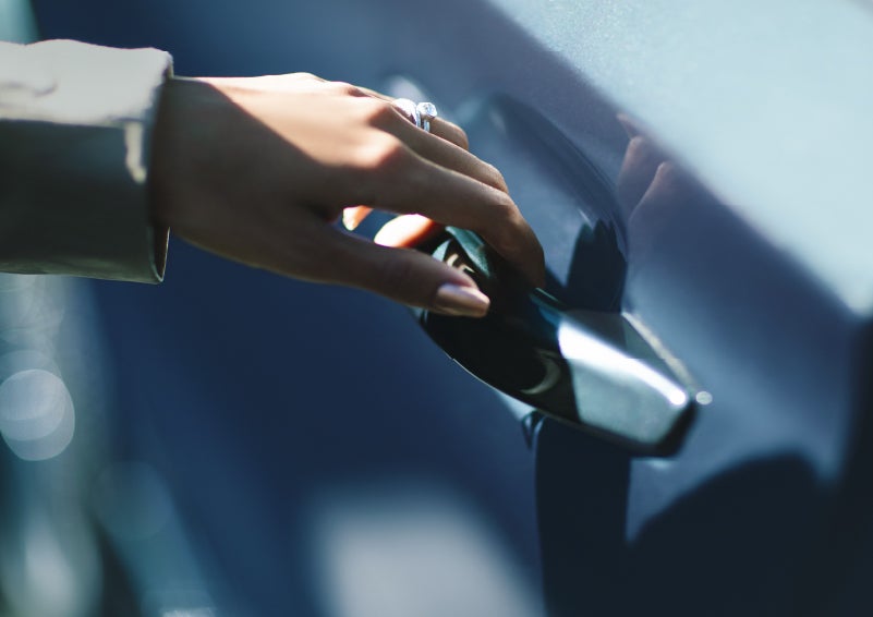 A hand gracefully grips the Light Touch Handle of a 2024 Lincoln Aviator® SUV to demonstrate its ease of use | Asheville Lincoln in Asheville NC