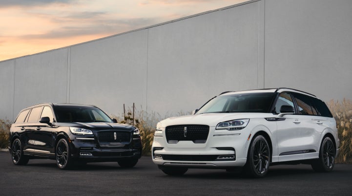 Two Lincoln Aviator® SUVs are shown with the available Jet Appearance Package | Asheville Lincoln in Asheville NC