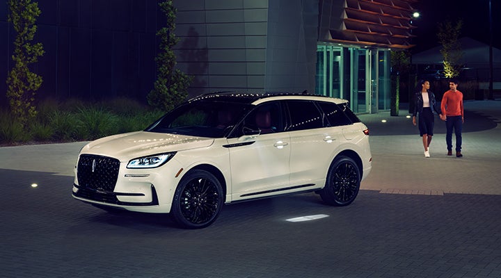 Two people approach a 2024 Lincoln Corsair® SUV featuring the available Jet Appearance Package. | Asheville Lincoln in Asheville NC