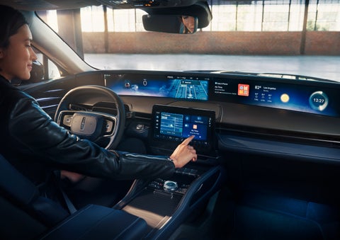 The driver of a 2024 Lincoln Nautilus® SUV interacts with the center touchscreen. | Asheville Lincoln in Asheville NC