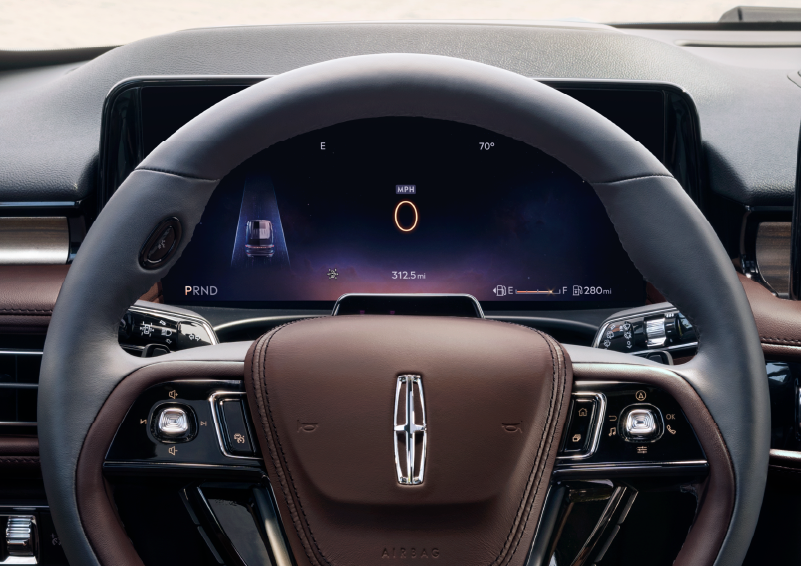 The steering wheel of 2025 Lincoln Aviator® SUV is shown with black and brown accents. | Asheville Lincoln in Asheville NC