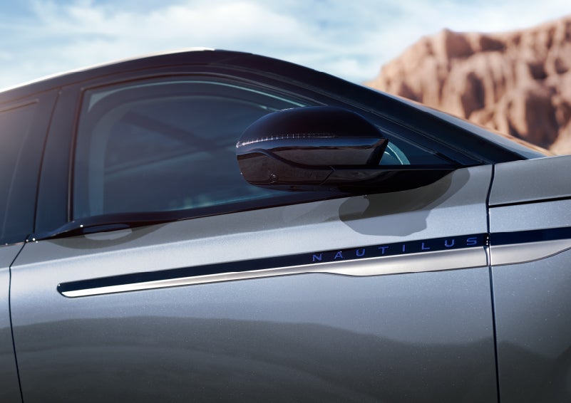 Blue lettering on the side of the vehicle that reads nautilus indicates the available hybrid powertrain. | Asheville Lincoln in Asheville NC