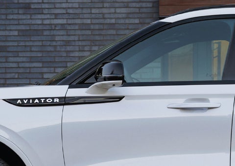 The driver’s side door and fender badging of a white 2026 Lincoln Aviator® SUV are showcased. | Asheville Lincoln in Asheville NC