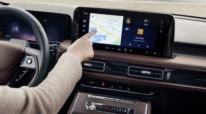 A person is tapping the center display touchscreen of a 2026 Lincoln Aviator® SUV. | Asheville Lincoln in Asheville NC
