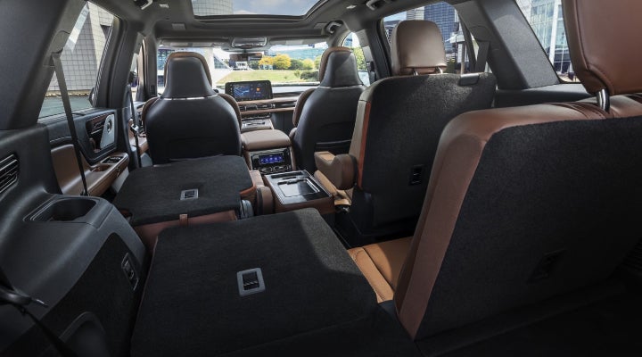 One side of the PowerFold® third-row seat and a second-row seat are folded forward in the 2026 Lincoln Aviator® SUV. | Asheville Lincoln in Asheville NC