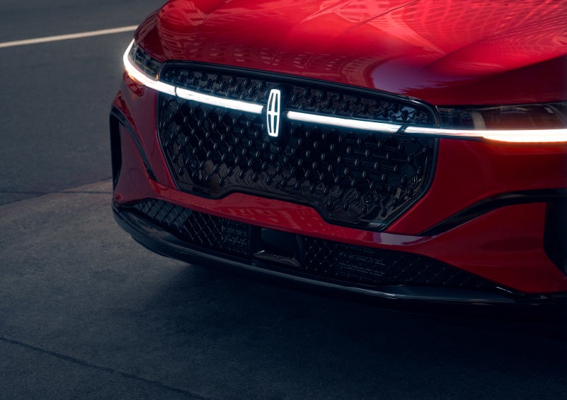 The available front LED light bar and center Lincoln Star logo glow at dusk. | Asheville Lincoln in Asheville NC