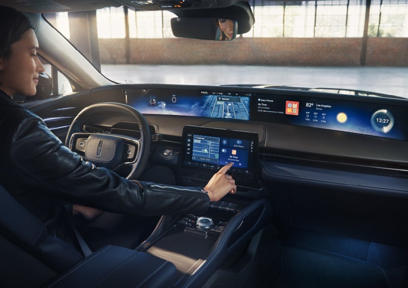 The driver of a 2026 Lincoln Nautilus® SUV interacts with the center touchscreen. | Asheville Lincoln in Asheville NC