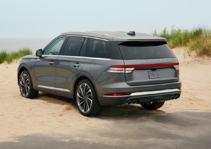 A 2027 Lincoln Aviator® SUV is parked next to sand dunes. | Asheville Lincoln in Asheville NC