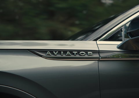 The driver’s side door and fender badging of a gray 2027 Lincoln Aviator® SUV are showcased. | Asheville Lincoln in Asheville NC