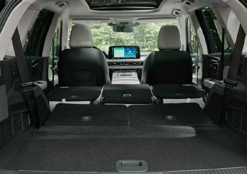 A rear to front view of the interior of a 2027 Lincoln Aviator® Black Label™ SUV shows the third and second rows folded flat | Asheville Lincoln in Asheville NC