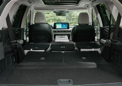 A rear to front view of the interior of a 2027 Lincoln Aviator® Black Label™ SUV shows the third and second rows folded flat | Asheville Lincoln in Asheville NC