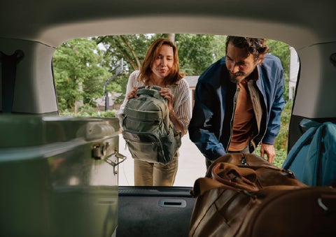 A couple loads luggage into the rear of a 2027 Lincoln Aviator® Black Label™ SUV..e 202 | Asheville Lincoln in Asheville NC